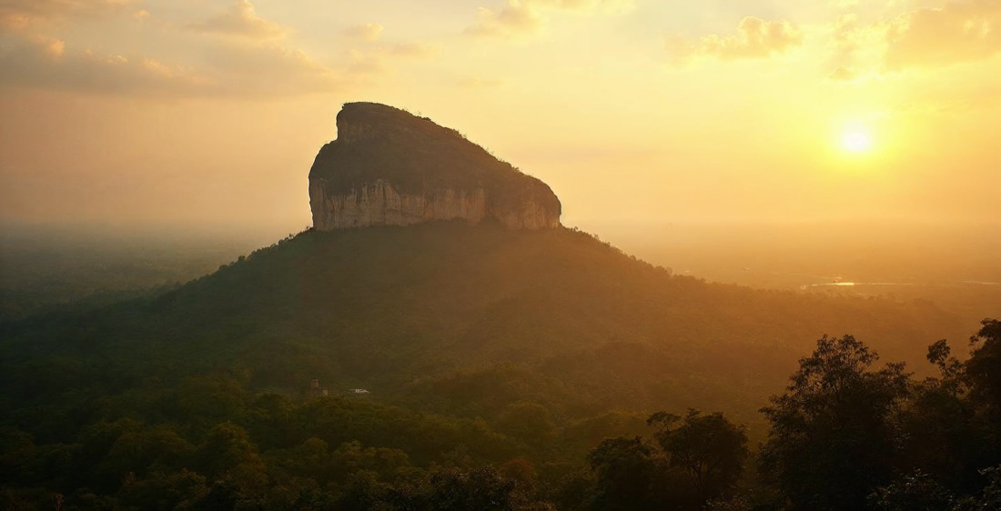 Sigiriya rock fortress in Sri Lanka at golden hour.