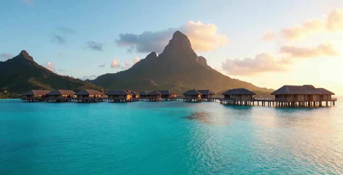 Bora Bora's overwater bungalows with Mount Otemanu at sunset, French Polynesia